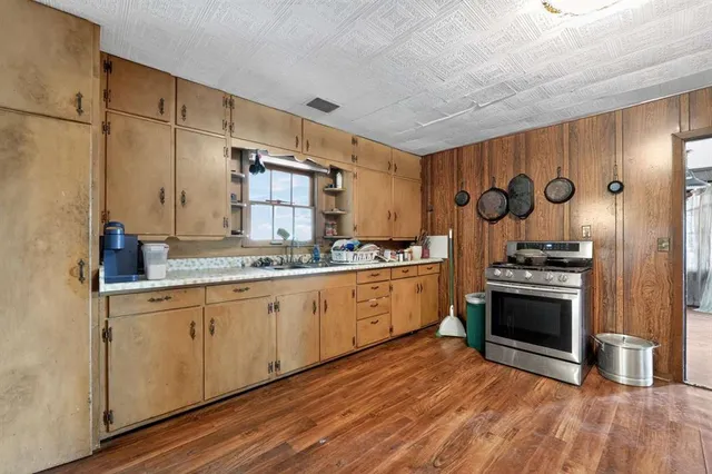 a kitchen with stainless steel appliances granite countertop a stove and a sink