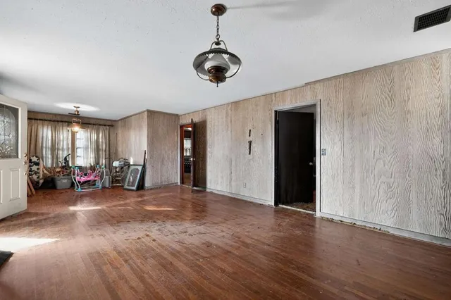 a view of a room with wooden floor gym equipment