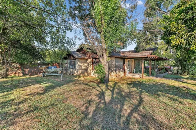 a view of a house with a tree back yard