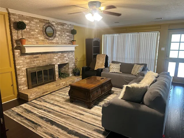 a living room with furniture and a fireplace
