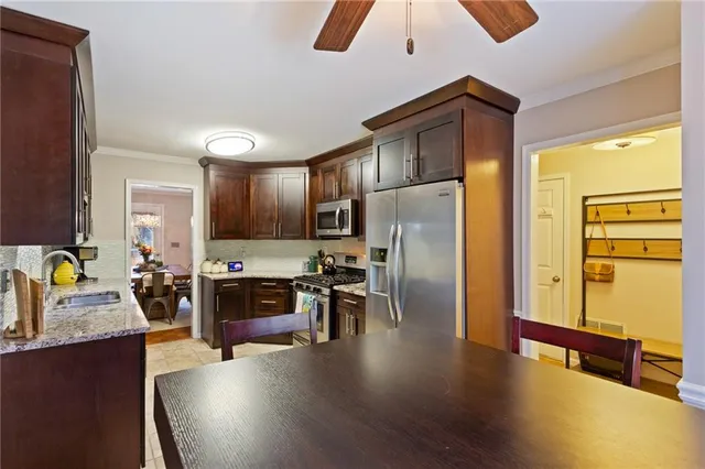 a bathroom with a granite countertop sink and a mirror with toilet