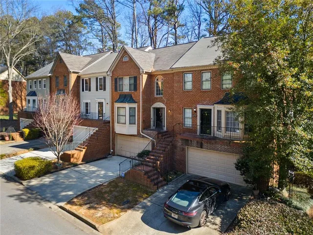 a front view of a house with a yard garage and outdoor seating