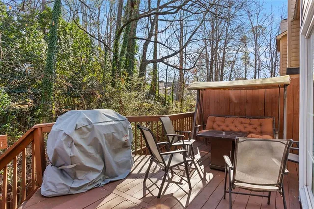 a view of a park with chairs and wooden fence