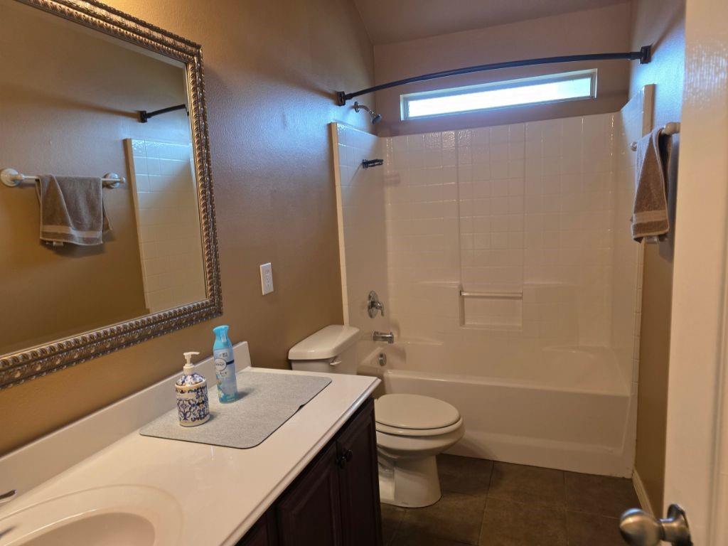 6320 Spring Ranch Drive Fort Worth, TX 76179 - Photo 13 of 24 Bathroom with a white vanity featuring an integrated sink and dark wood-finish cabinetry