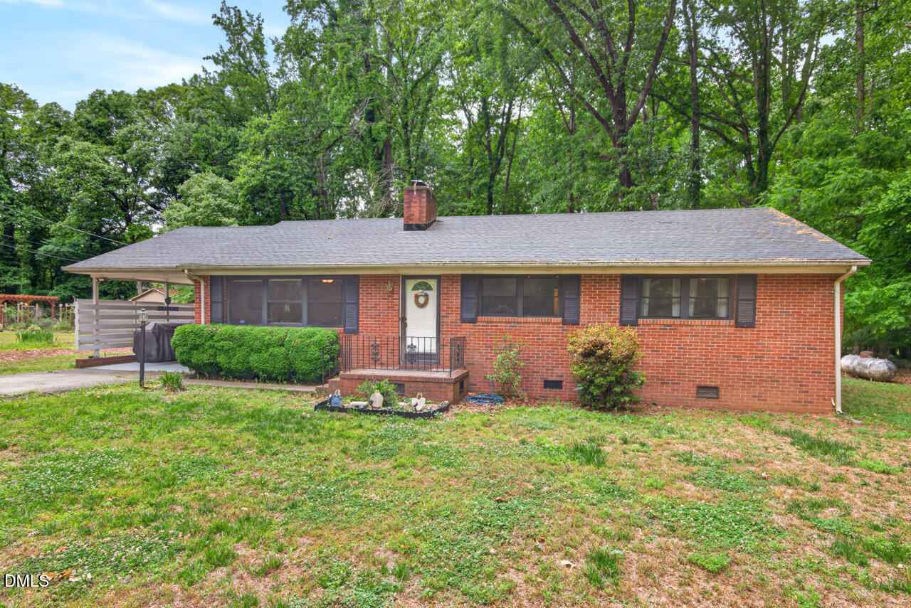 1420 Goodwin Road Durham, NC 27712 - Photo 2 of 54 a front view of a house with a garden and yard