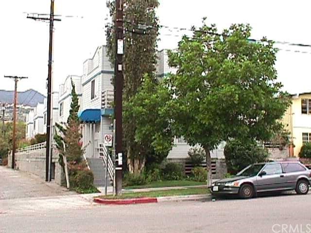 a view of a street with a cars on the road