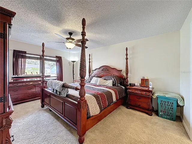 a bedroom with bed tv and dresser