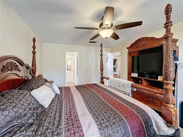 a bathroom with a granite countertop sink a toilet a mirror and shower