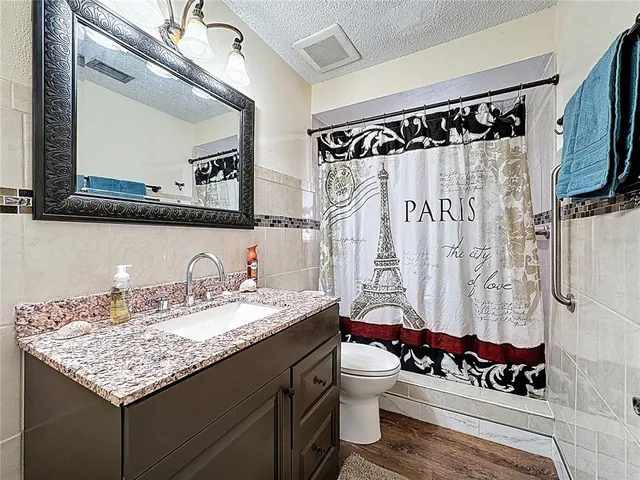 an empty room with windows and ceiling fan