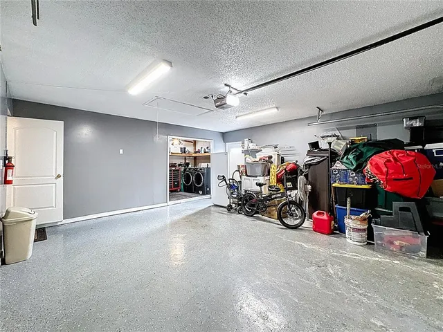 a room with pool table and windows