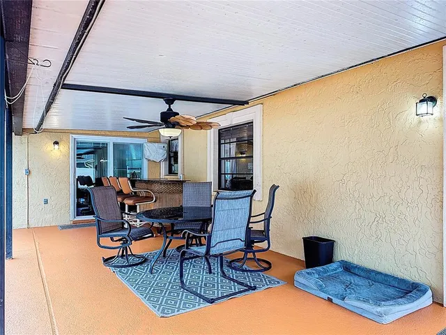 a front view of a house with a yard and potted plants