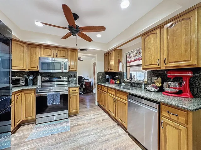 a kitchen with stainless steel appliances granite countertop a stove and a sink