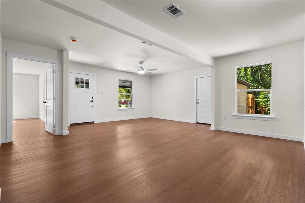 513 East Union Bower Road Irving, TX 75061 - Photo 8 of 34 Wood-finish flooring throughout, white interior walls, and a ceiling fan with integrated lighting