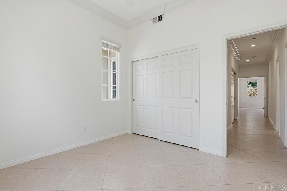 672 Inverlochy Drive Fallbrook, CA 92028 - Photo 44 of 75 an empty room with windows and entrance