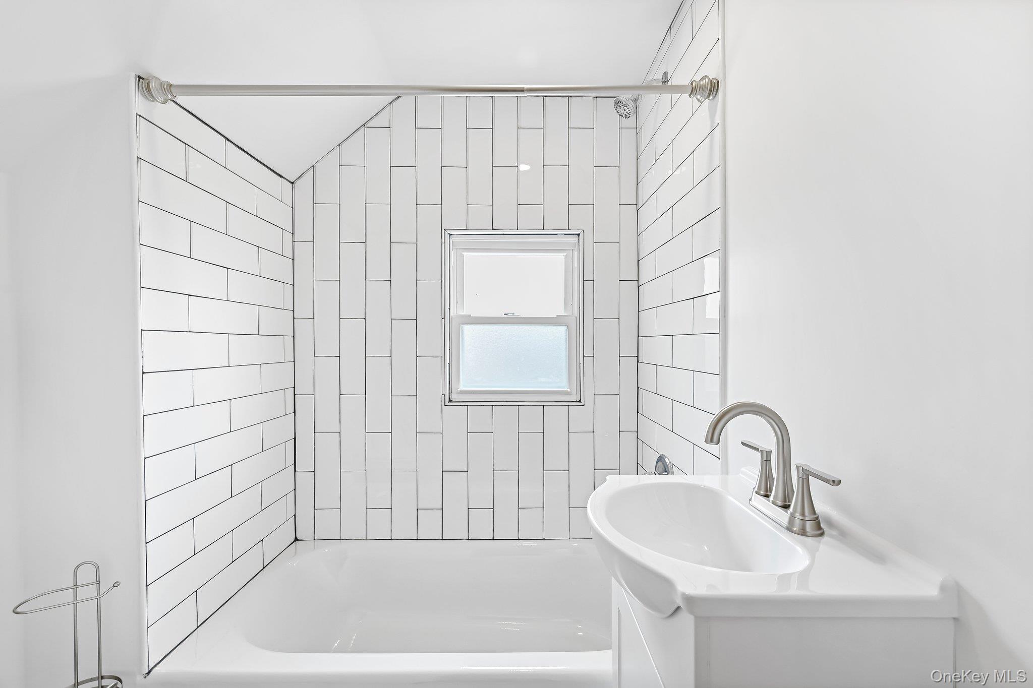 12 Thomas Place, Unit 3 New Rochelle, NY 10801 - Photo 7 of 7 a bathroom with a sink a shower and a bathtub