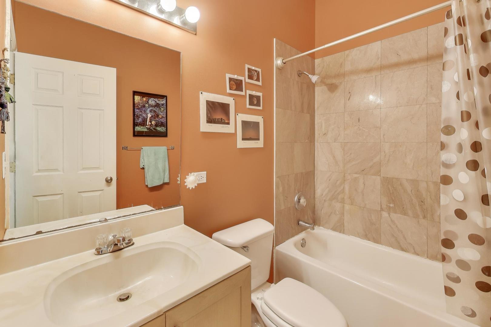 2451 South Western Avenue, Unit 2S Chicago, IL 60608 - Photo 12 of 16 a bathroom with a sink a toilet and shower