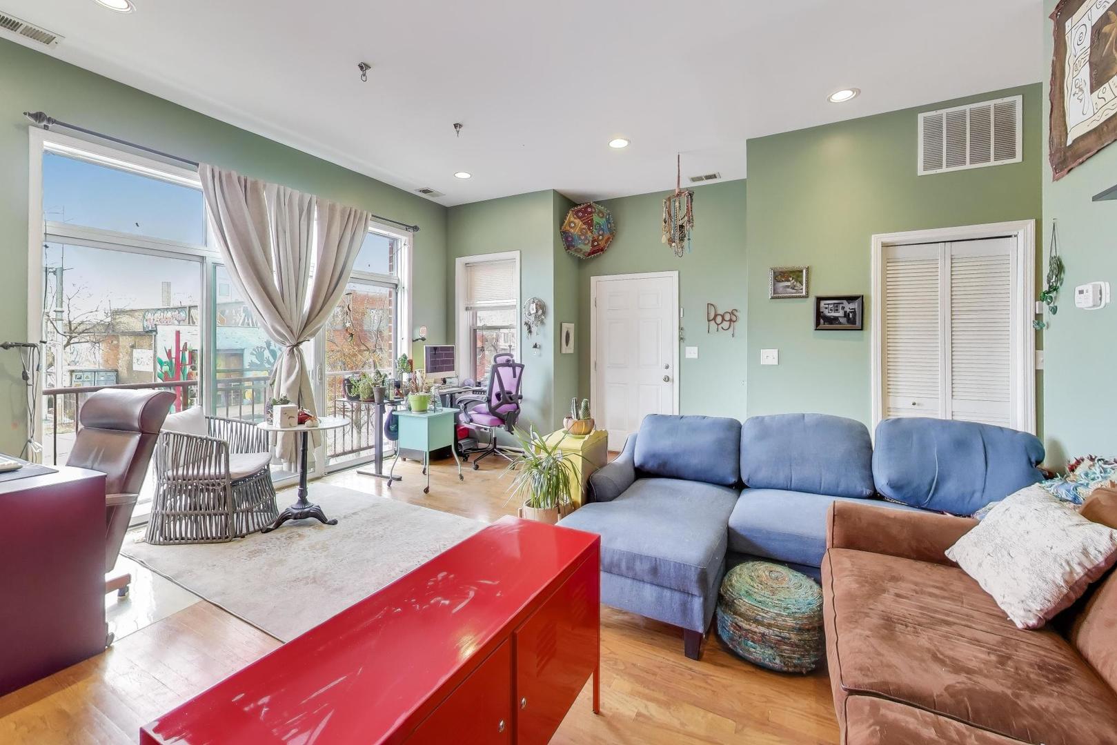 2451 South Western Avenue, Unit 2S Chicago, IL 60608 - Photo 2 of 16 a living room with furniture and a large window