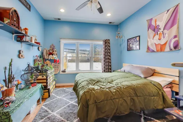 a bed sitting in a bedroom next to a window