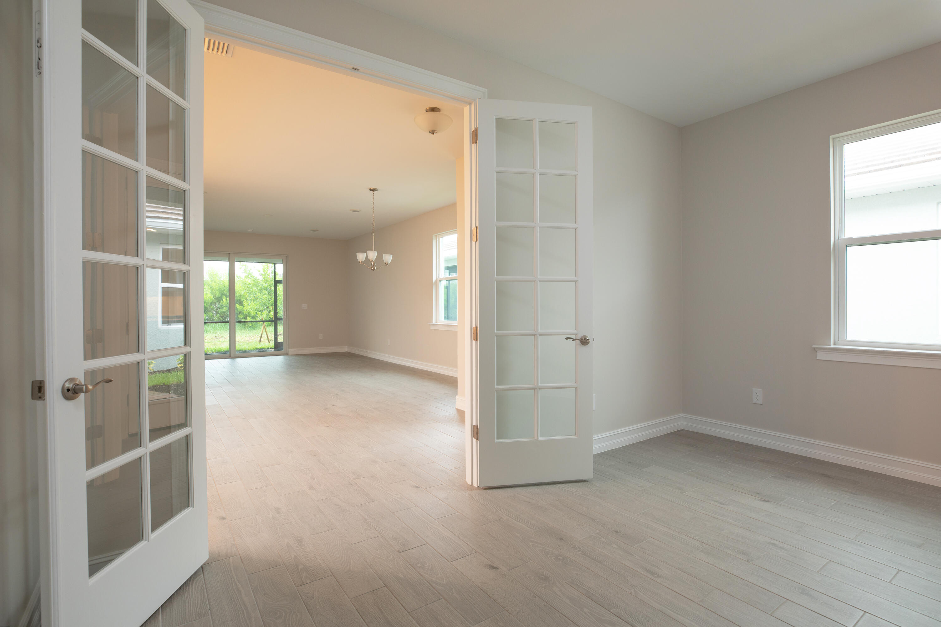 911 Enbrook Loop Naples, FL 34114 - Photo 8 of 20 an empty room with windows