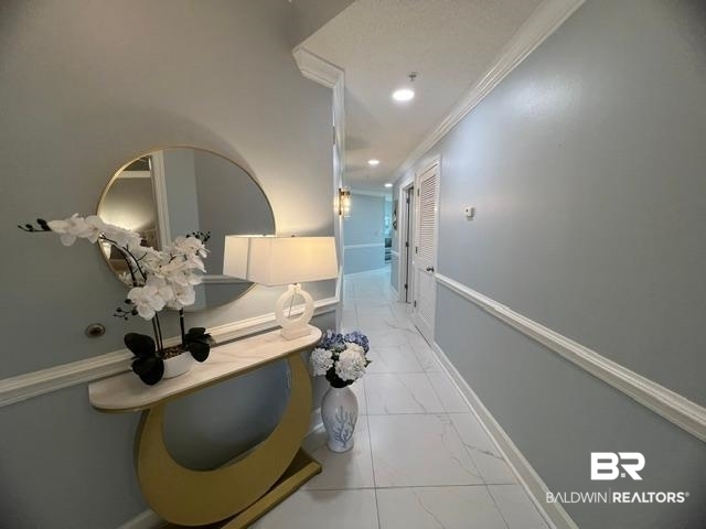 27580 Canal Road, Unit 1210 Orange Beach, AL 36561 - Photo 23 of 28 Corridor featuring crown molding, light marble finish floors, and recessed lighting