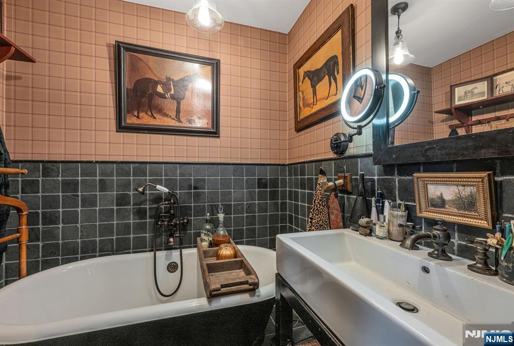 26 Short Road Bloomingdale, NJ 07420 - Photo 30 of 46 a bathroom with a sink and a bathtub
