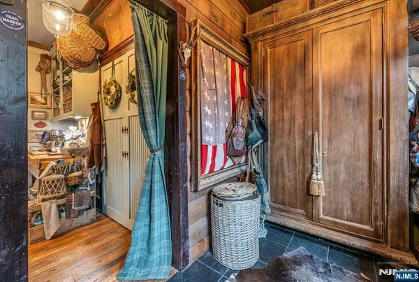 a dining room with wooden floor and furniture