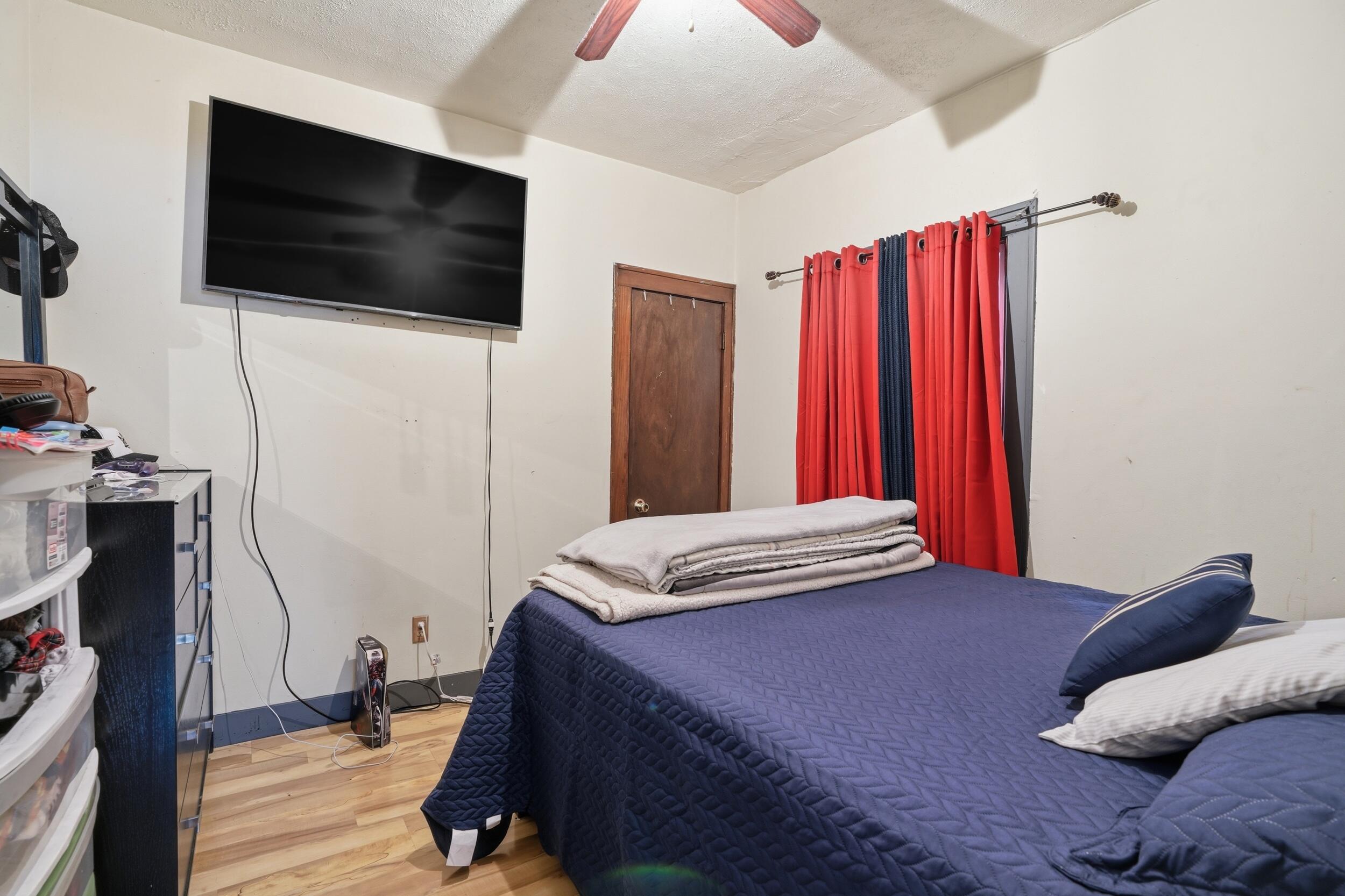 6249 Monroe Avenue Hammond, IN 46324 - Photo 13 of 22 a bedroom with a bed and a flat screen tv