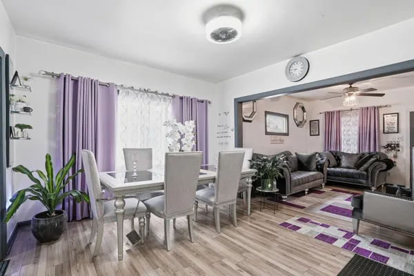 a living room with furniture potted plant and a large window