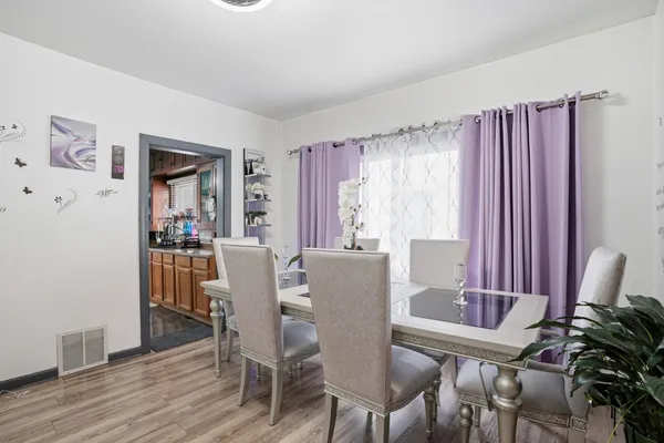 a view of a dining room with furniture window and wooden floor