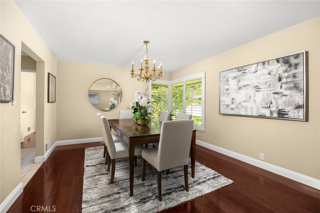 1439 Wembley Road San Marino, CA 91108 - Photo 5 of 45 a view of a dining room with furniture a chandelier and wooden floor