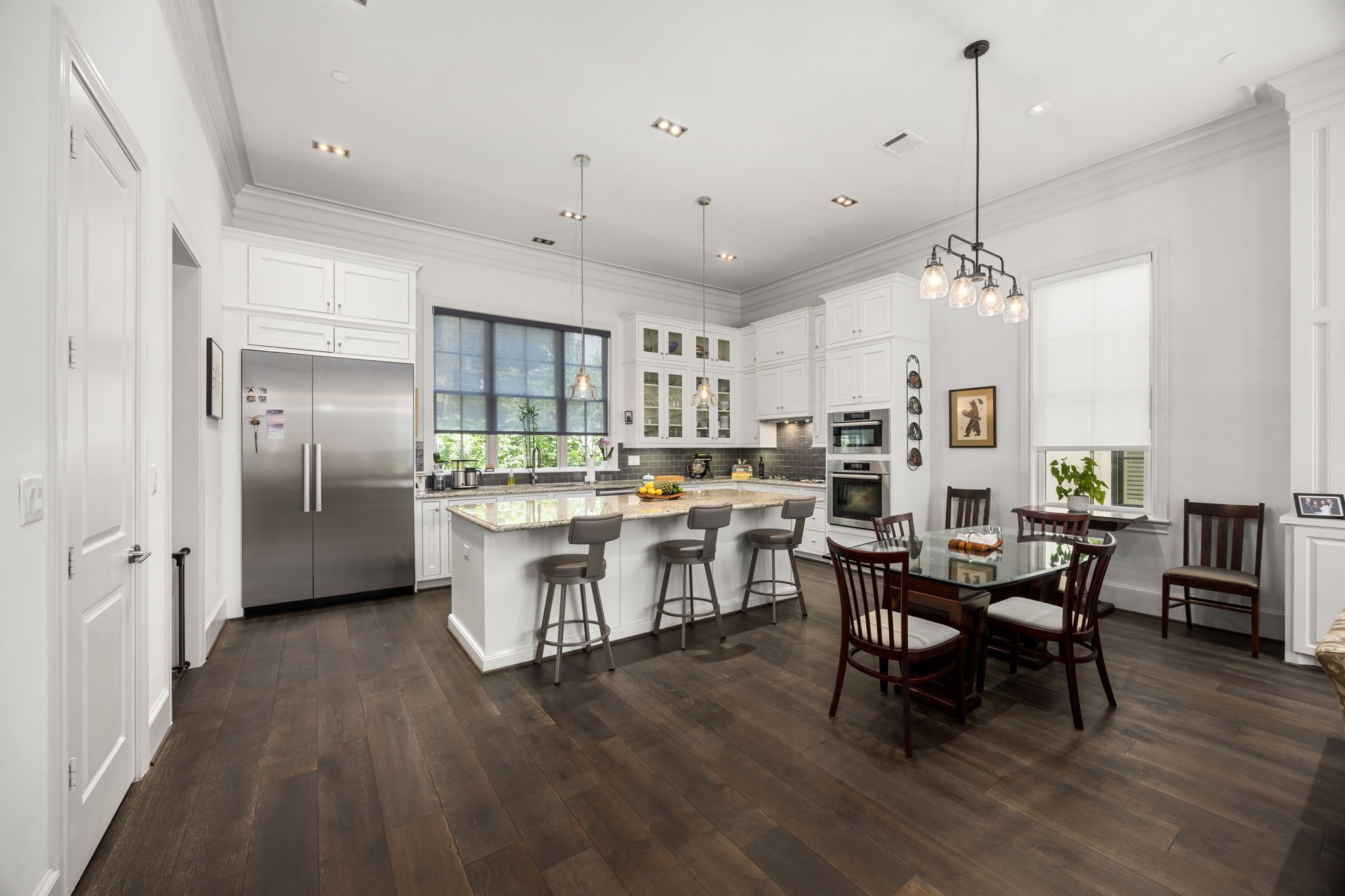 11 Robita Street Houston, TX 77019 - Photo 16 of 32 a kitchen with stainless steel appliances kitchen island hardwood floor and a sink
