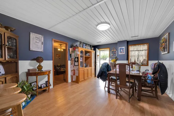 a dining room with furniture window and wooden floor