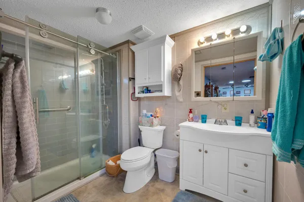 a bathroom with a double vanity sink toilet and shower