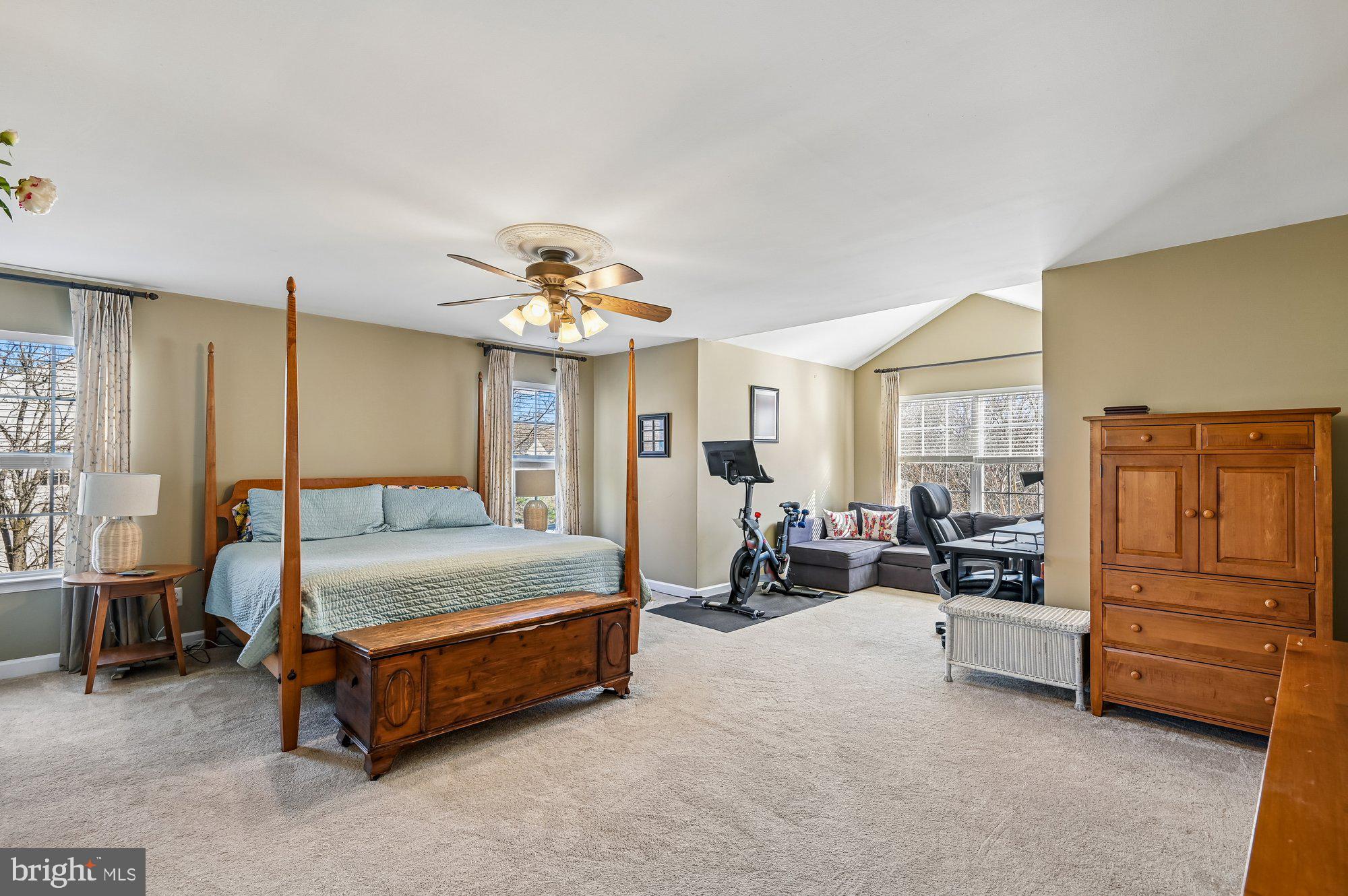 3225 Homewood Road Davidsonville, MD 21035 - Photo 15 of 33 a spacious bedroom with a bed a table and with chair