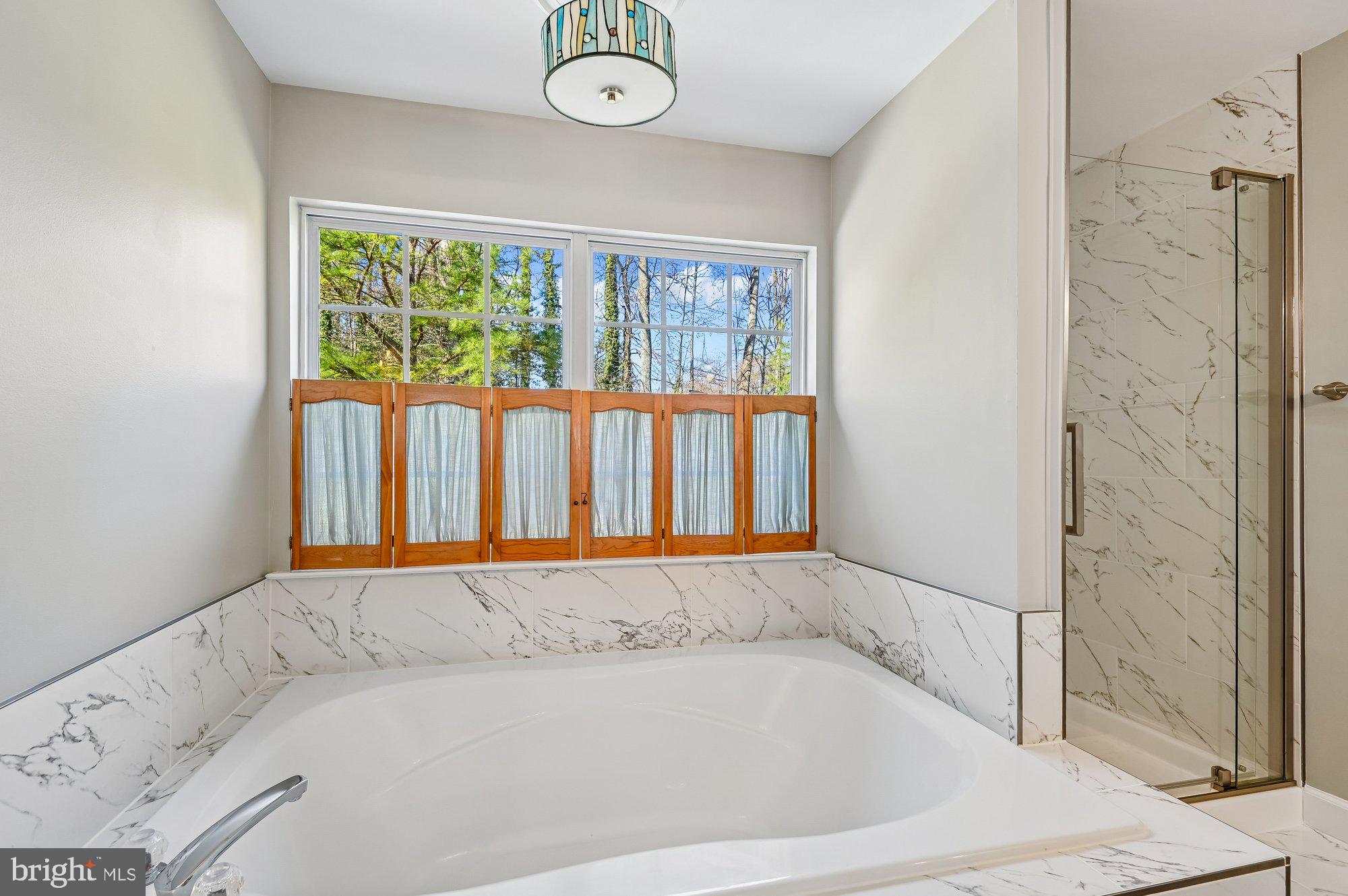 3225 Homewood Road Davidsonville, MD 21035 - Photo 16 of 33 a bathroom with a bathtub and a window