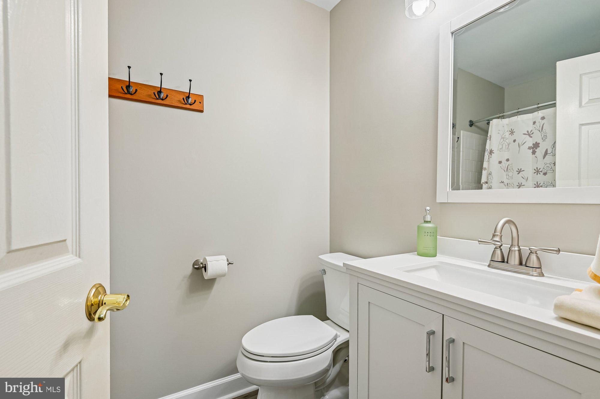3225 Homewood Road Davidsonville, MD 21035 - Photo 21 of 33 a bathroom with a toilet sink and mirror