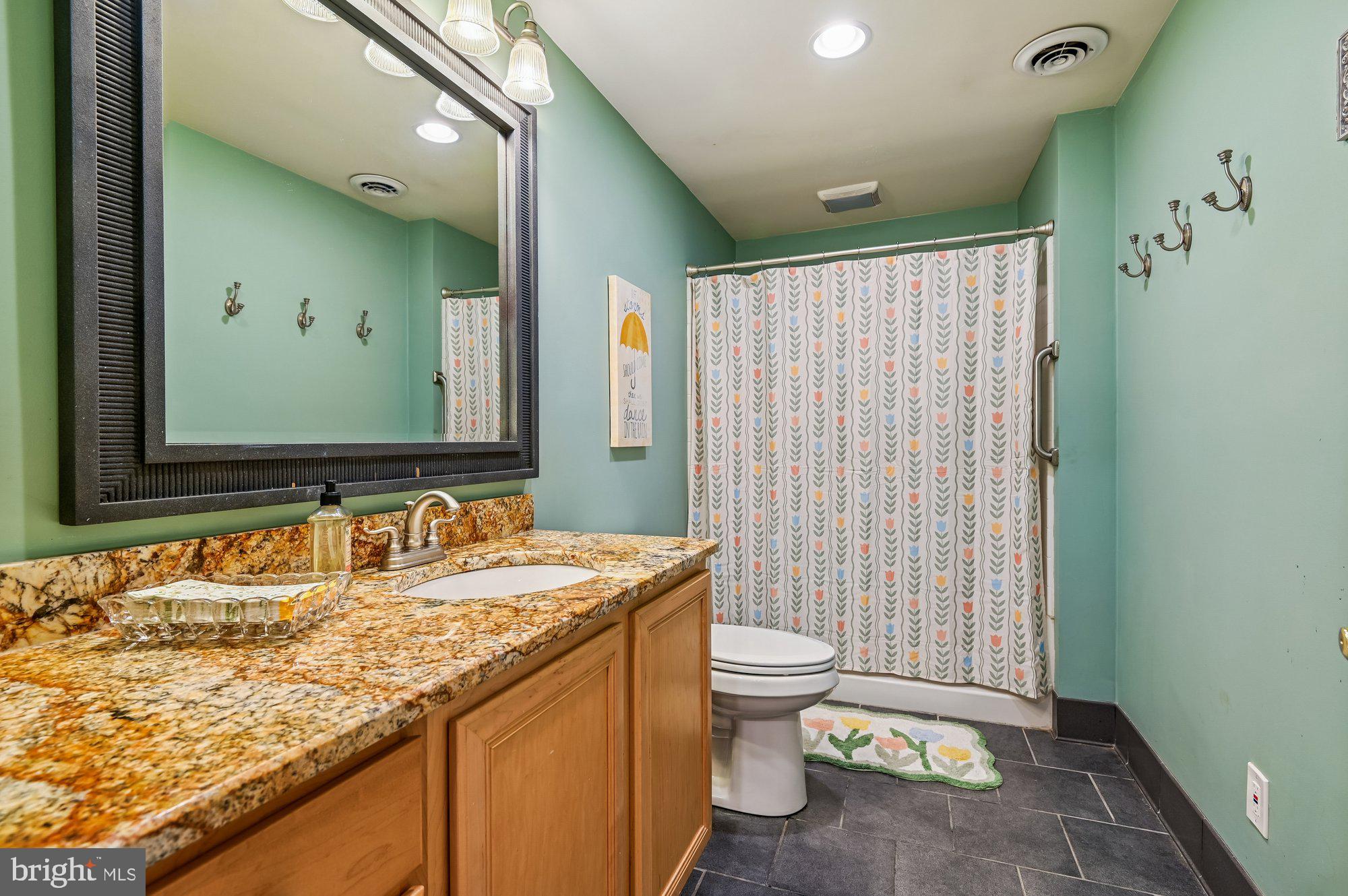 3225 Homewood Road Davidsonville, MD 21035 - Photo 27 of 33 a bathroom with a granite countertop sink and a mirror