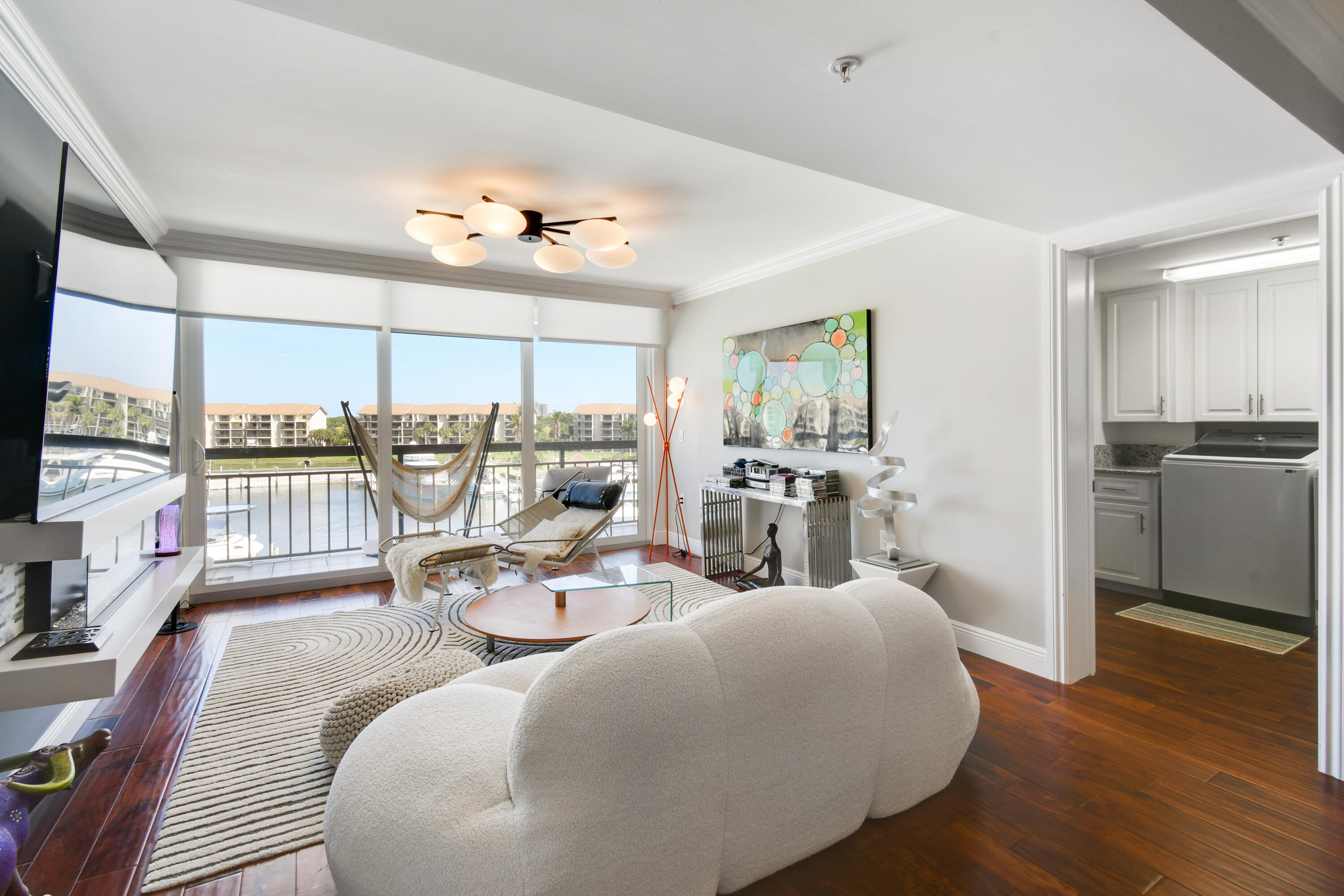 2401 Marina Isle Way, Unit 503 Jupiter, FL 33477 - Photo 14 of 46 a living room with furniture large windows and wooden floor