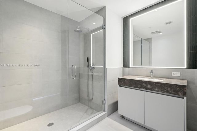 a bathroom with a tub sink and mirror