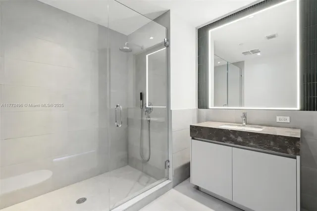 a bathroom with a tub sink and mirror