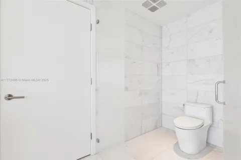 a large white bed in a white room