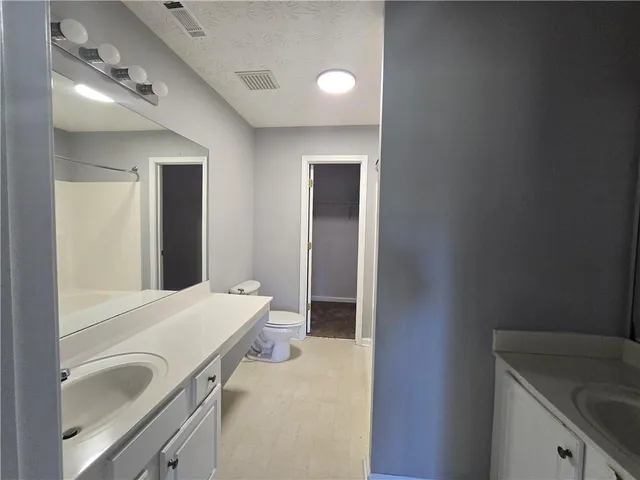 a en suite bathroom with a sink and a mirror