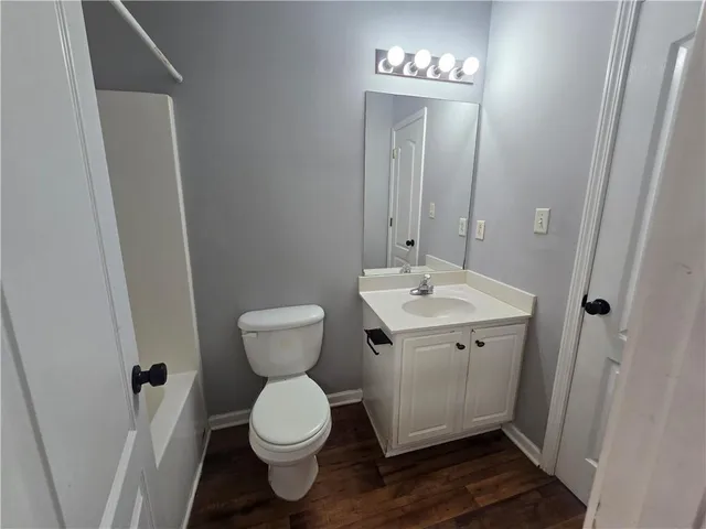 a bathroom with a toilet sink and a mirror