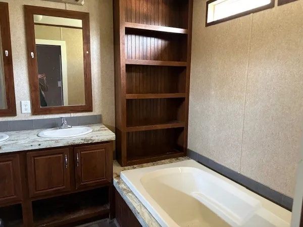 a bathroom with a tub and a sink
