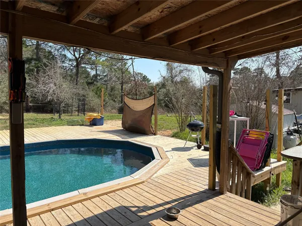 a view of balcony with wooden floor and outdoor seating