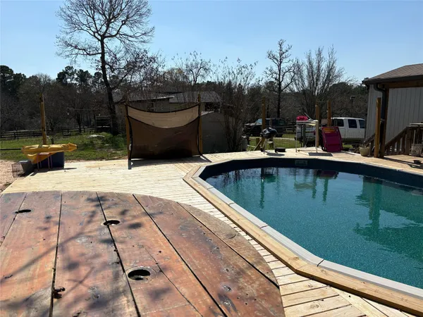 a view of patio with swimming pool outdoor seating