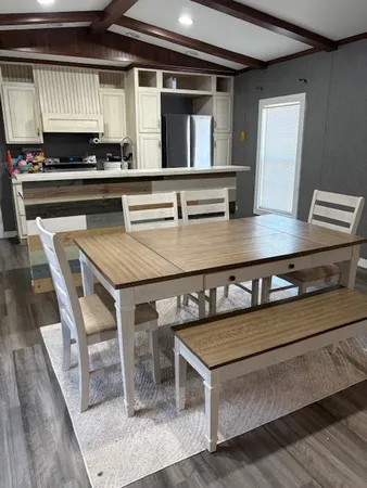 a kitchen with a stove a sink and cabinets