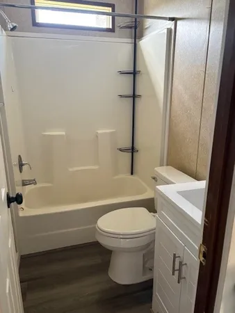 a white toilet sitting next to a bath tub