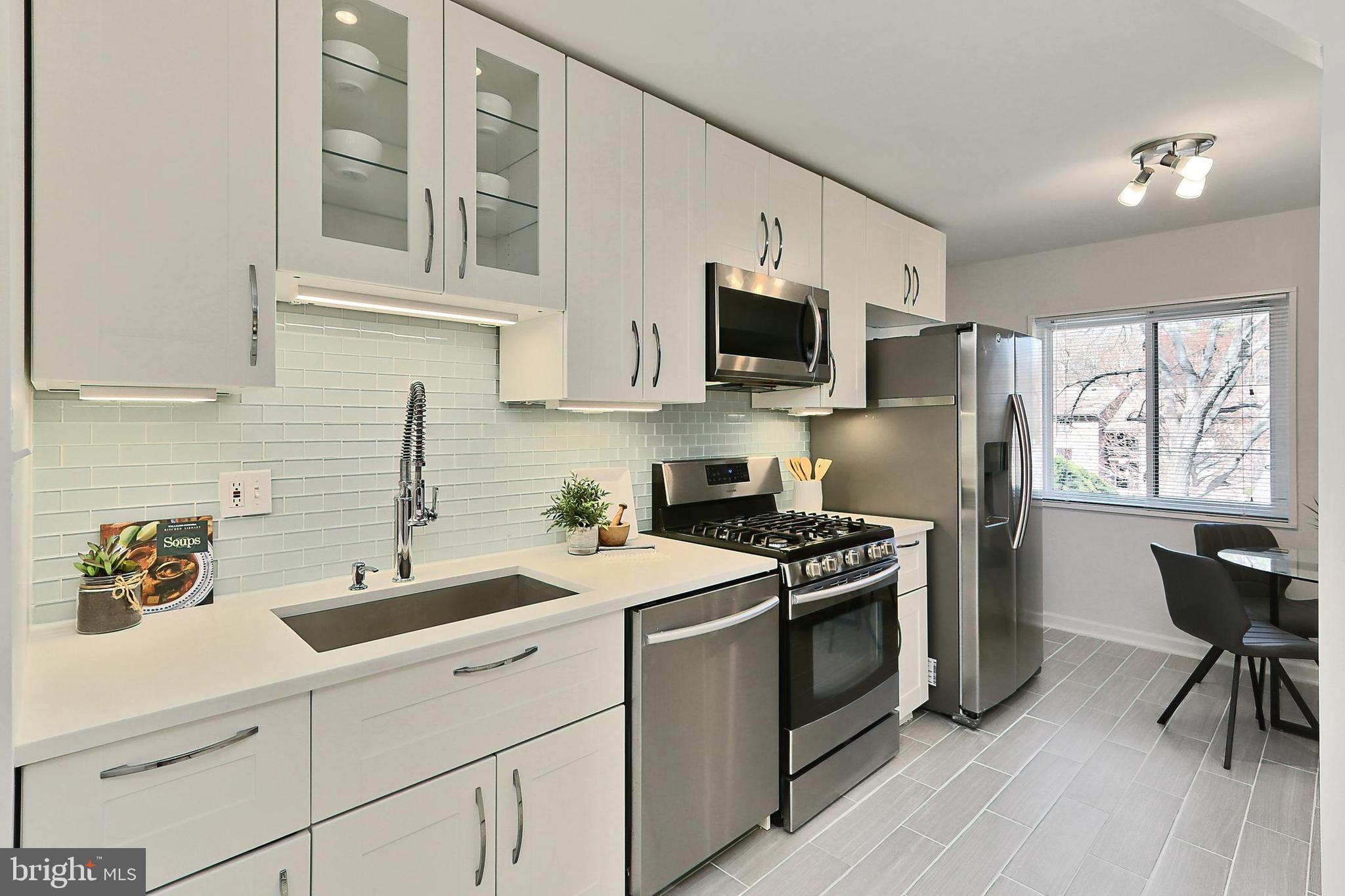 1439 Northgate Square, Unit 12A Reston, VA 20190 - Photo 15 of 40 Quartz Countertops w/ Glass Subway Tile Backsplash