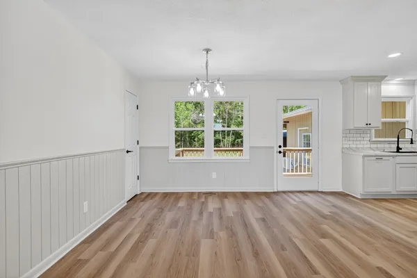 a view of wooden floor and windows in a room